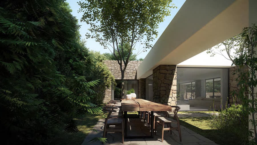Stone-clad house with a shaded garden dining terrace beneath mature trees