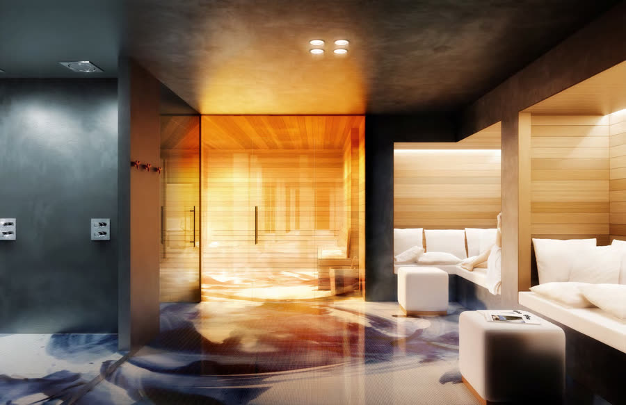 Dark wood and charcoal sauna lounge warmed by low amber lighting